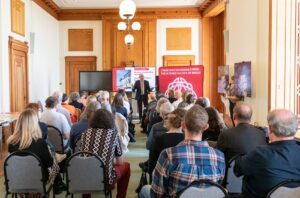 Dr Rhodri Llwyd Morgan standing in front of an audience at the National Library of Wales