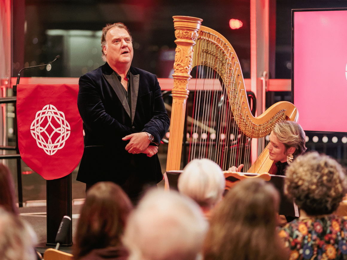 Bryn Terfel singing to a crowd at the Senedd in Cardiff accompanied on the harp by his wife Hannah Stone.